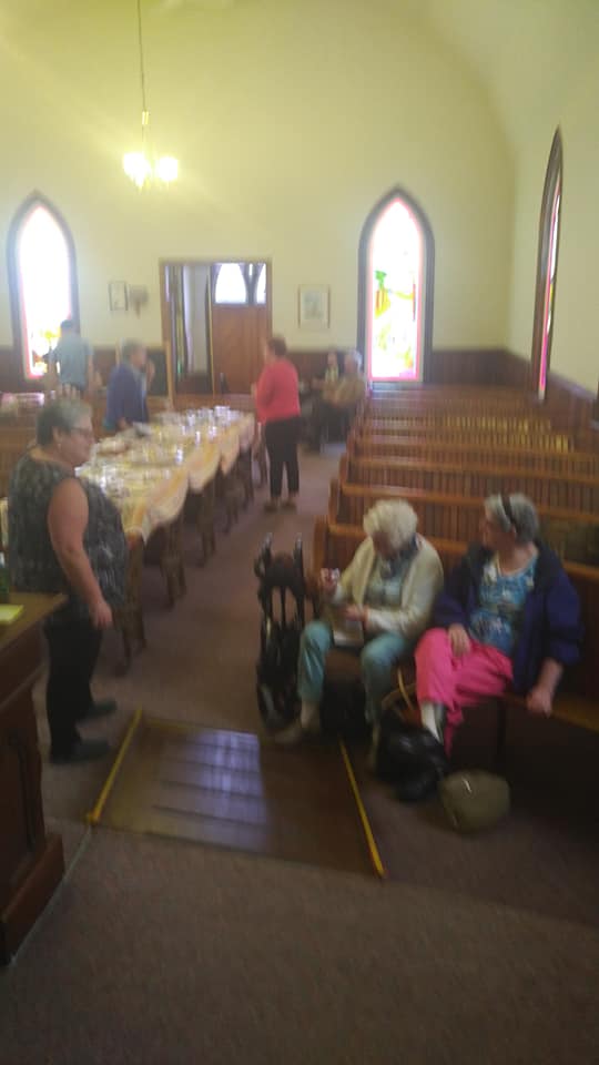 Church members gathering for fellowship inside the church